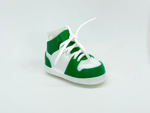 Green and white sneaker on a light gray background