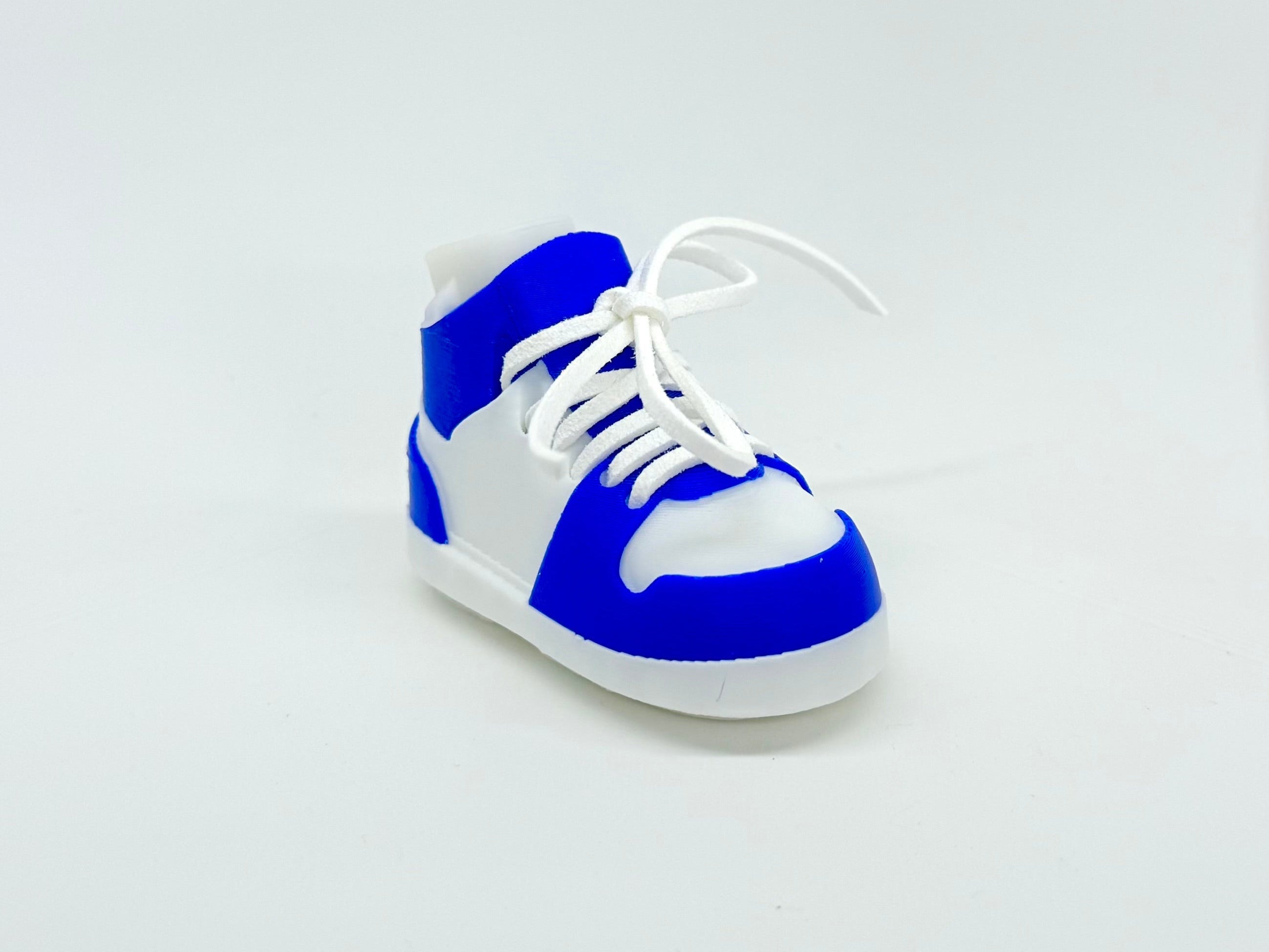 Blue and white sneaker on a light gray background
