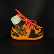 Sugar Skull Shoe Pair, side view. Orange and black shoe shell with a sugar skull graphic and orange laces.