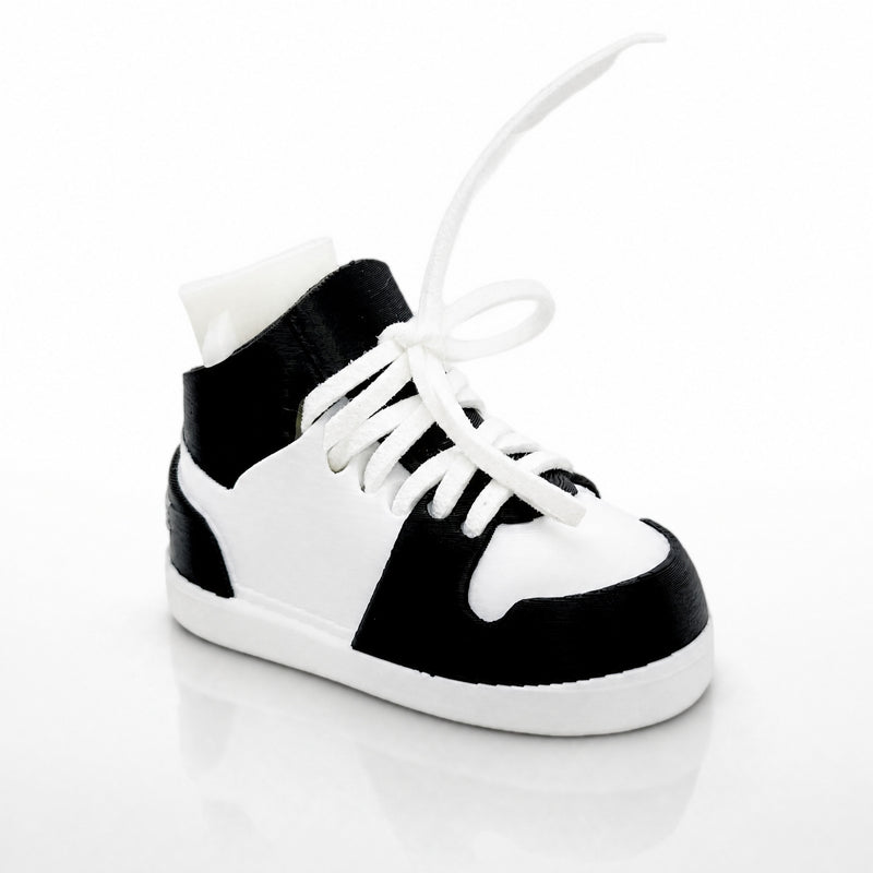 Black and white high-top sneaker on a light gray background