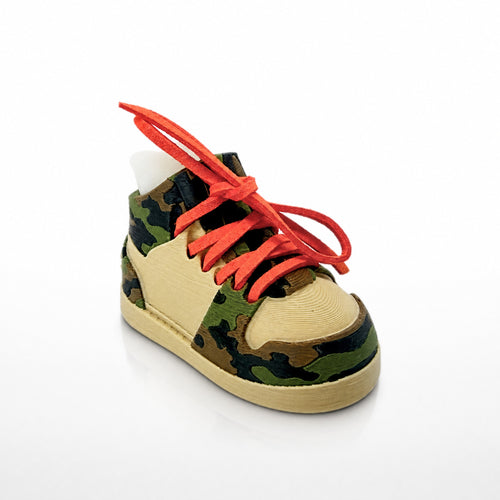 Traditional Camo Shoe Pair, three-quarter view. Sand colored shoe shell with green, brown and black camo panels and orange laces.